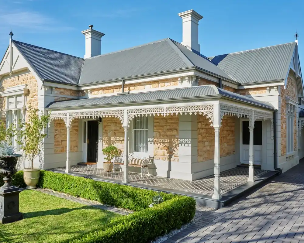 Freshly painted heritage sandstone home with decorative verandah in Sydney